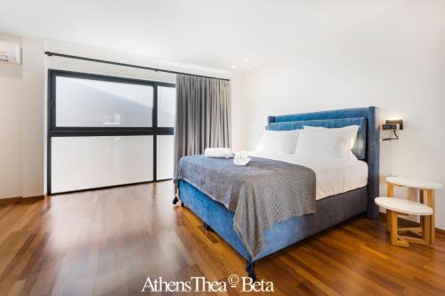 a bedroom with a bed and a table and a chair at AthensThea Beta Luxury Penthouse Apt in Omonia in Athens