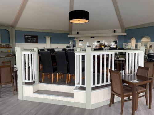 a dining room with a table and a bar at G10 Hoburne Devon Bay pet friendly in Goodrington