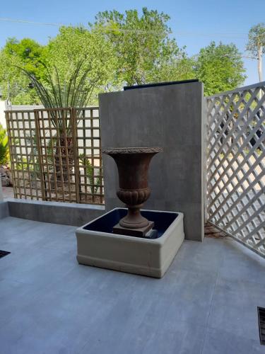 a vase sitting in a box in front of a fence at 64 on Malabor in Pretoria