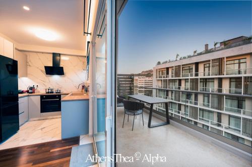 a balcony with a table and a view of a building at AthensThea Luxury Penthouse Apt in Omonia 115sq.m. in Athens