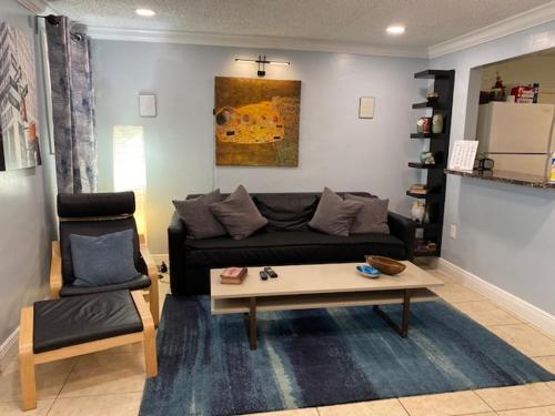 a living room with a couch and a coffee table at Modern 2/1 Apt near Midtown and Beaches in Miami