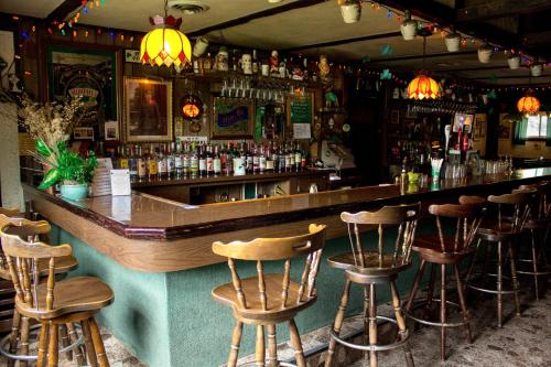 a bar with a bunch of bar stools at Jimmy OConnor's Windham Mtn Inn in Windham