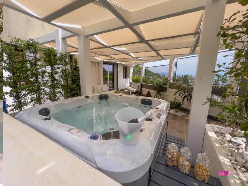 a hot tub in the middle of a patio at GT HOUSE FONTANA LIMITE in Vietri sul Mare