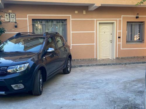 a black car parked in front of a house at Vila Murati in Tirana