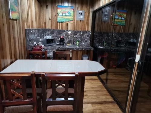 a kitchen with a table and a counter top at Tree houses Bosque Nuboso Monteverde in Monteverde Costa Rica