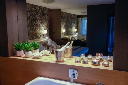 a bathroom with a counter with a sink and a mirror at Penzion Solid Spa in Mladá Boleslav