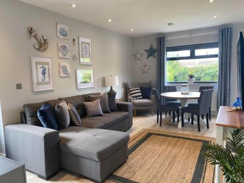 a living room with a couch and a table at The Annexe Porthcawl Pet Friendly 2 Bedroom Flat with King Size bed bunk beds and sofa bed sleeps up to 5 people in Nottage