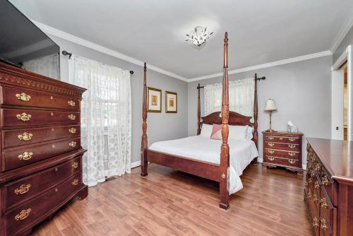 Schlafzimmer mit Himmelbett und Kommode in der Unterkunft HOLIDAY HOME 5 BR 3 BA Near Beaches and Venues in Hampton
