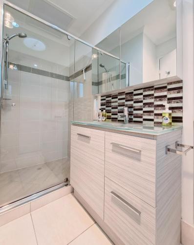 a bathroom with a shower and a walk in shower at Noosa River Retreat Holiday Apartments in Noosaville