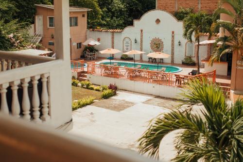 a view from a balcony of a pool with umbrellas at Hotel Condesa in Comayagua