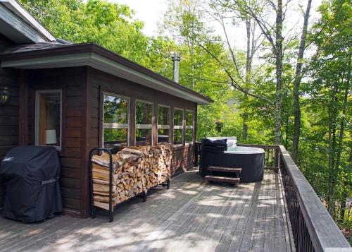 a screened in porch of a cabin with trees at Mountaintop Lookout with Hot Tub under the Stars in Hunter