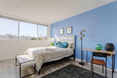 a bedroom with a bed and a blue wall at Stunning Hollywood Townhouse with Sunny views in Los Angeles