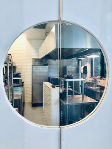 a mirror reflection of a kitchen with stainless steel appliances at Pousada Rio144 in Rio de Janeiro