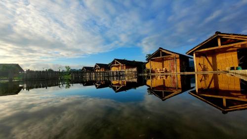 a group of houses on a body of water at Toong homestay in Ha Giang