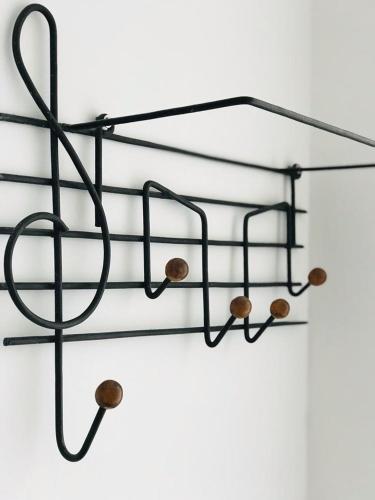 a black metal rack with wooden spheres on it at Posada Los Horneros in Coronel Suárez