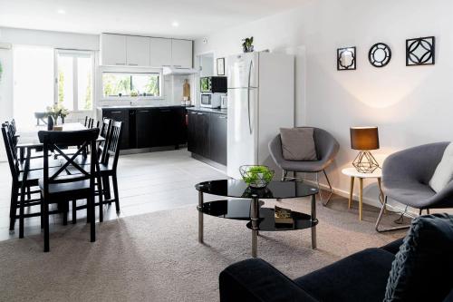 a living room with a refrigerator and a table at Sherrard Spacious Family Place in Nerrina