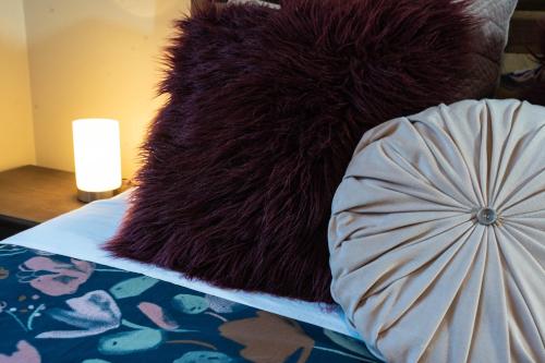 a black furry rug on a bed with a lamp at Lake Esmond Place in Canadian