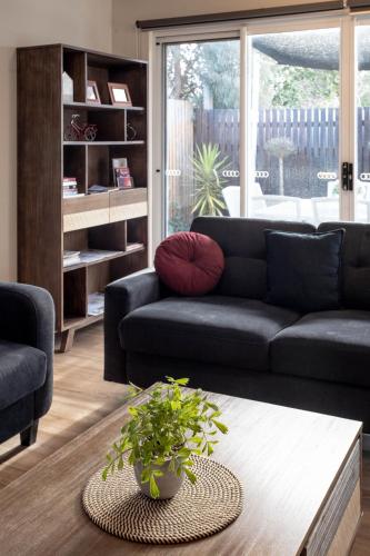 a living room with a couch and a coffee table at Lake Esmond Place in Canadian