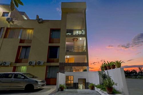 a building with a car parked in front of it at Hotel Terminal View in Bangalore