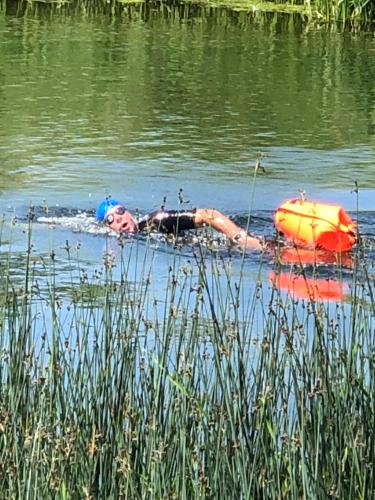 a person is laying on a raft in the water at Canty’s in West Ord