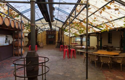 a restaurant with tables and chairs and a glass ceiling at Keilor Motor Inn in Keilor