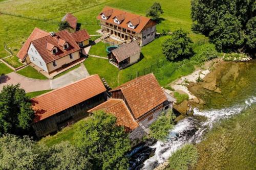 an aerial view of a house and a river at Riverside Suite Mobile Homes in Gradac