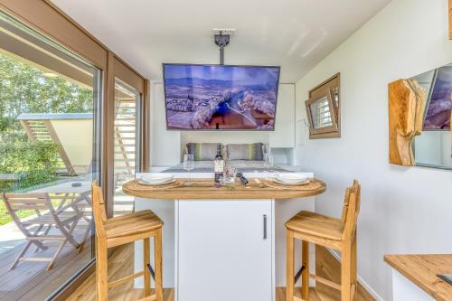 a bathroom with a sink and two chairs at Riverside Suite Mobile Homes in Gradac