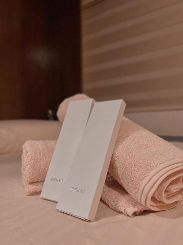 a pile of towels sitting on top of a bed at City View at The Persimmon Studios in Cebu City