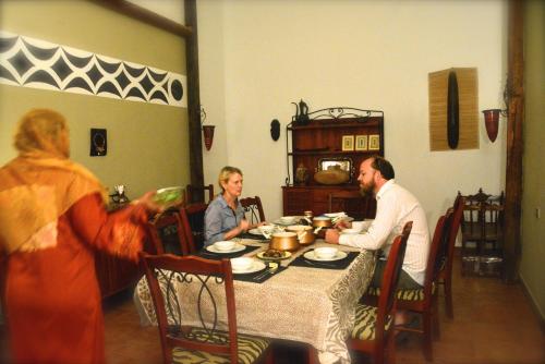 a group of people sitting at a dinner table at Nubian Holiday House Aswan in Aswan