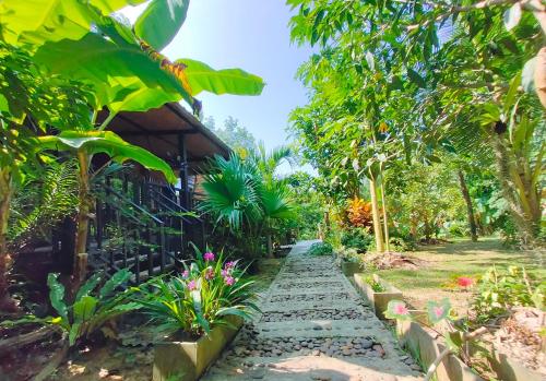 a garden path in front of a house at Kohmook Nurse House in Koh Mook