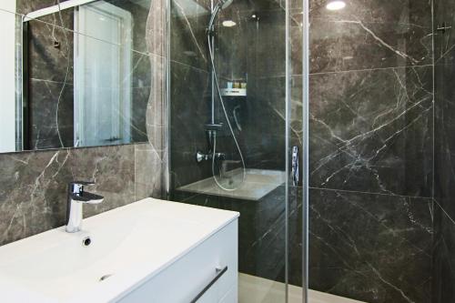 a bathroom with a shower with a sink and a glass shower stall at Phaedrus Living: Luxury Suite Nicosia 510 in Nicosia
