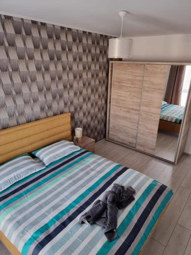 a bedroom with a bed with clothes on it at Best View Apartment in Braşov