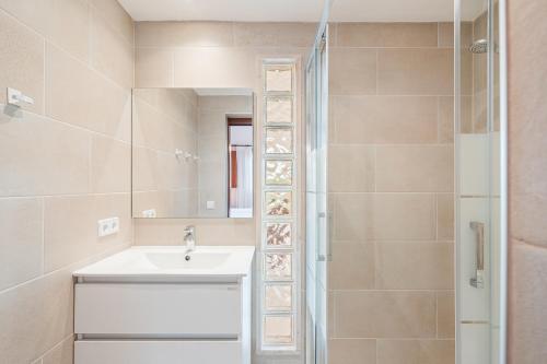 a bathroom with a sink and a mirror at Villa Rosa in Cala Santanyi