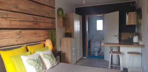 a room with a bed and a bathroom with a toilet at NORTH in Jastrzębia Góra