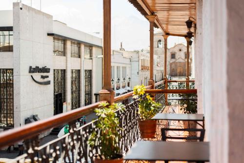 a balcony with benches and flowers on a building at Le Foyer Arequipa in Arequipa