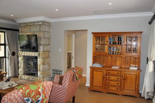 a living room with a couch and a fireplace at Sunbird Haven Self-Catering Sleeps 8 in Clarens