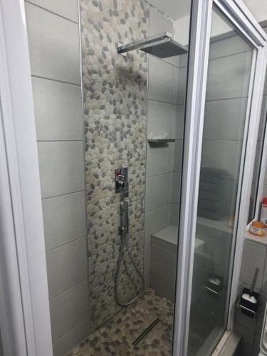 a shower with a glass door in a bathroom at DURBAN BEACHFRONT - Tenbury 903 in Durban