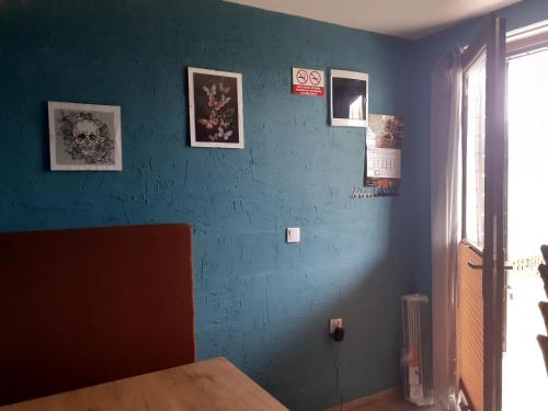 a room with a blue wall with pictures on it at Morska Bryza in Chłopy