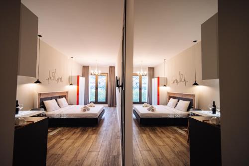 a large room with two beds and two sinks at Wine Rock Hotel in Tbilisi City