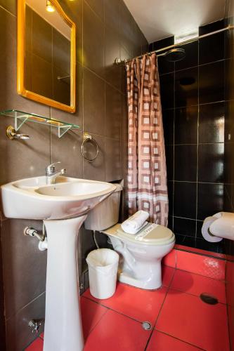 a bathroom with a white sink and a toilet at Le Foyer Arequipa in Arequipa