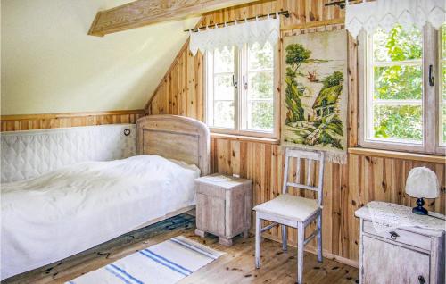 una camera con letto, sedia e finestre di Awesome Home In Osiek With Kitchen a Osiek