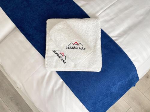 a white napkin on top of a bed at Csatári Ház - Szekszárd in Szekszárd