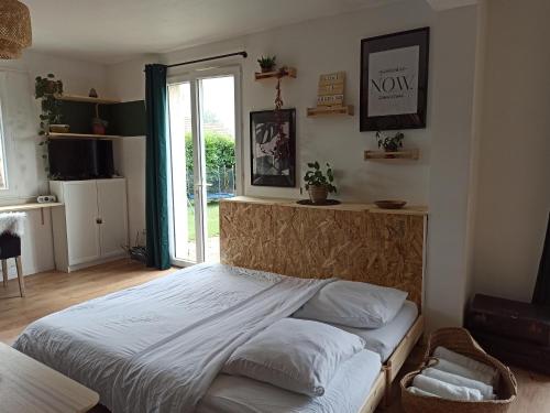 a bedroom with a bed and a window at La Tanière aux Loups in Montévrain