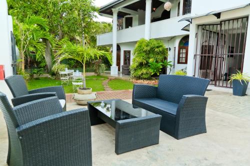 a patio with two chairs and a coffee table at Maria Villa in Negombo