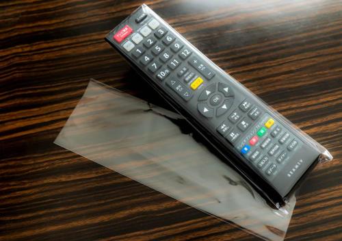 a remote control sitting on top of a table at APA Hotel & Resort Osaka Umeda Eki Tower in Osaka