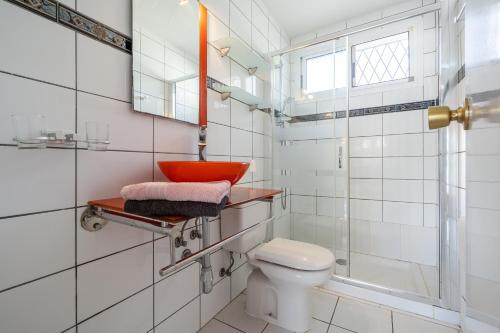 ein Badezimmer mit einem roten Waschbecken und einem WC in der Unterkunft Villa La Palmera in Cambrils