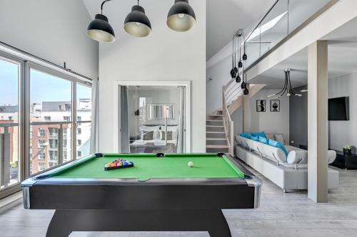 a pool table in a living room with a bill at Waterlane Riverside SPA, Pool & Gym by Downtown Apartments in Gdańsk
