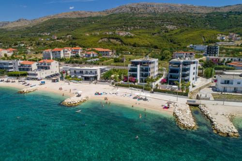 an aerial view of a beach with people in the water at VIPo Prestige Apartments in Podstrana