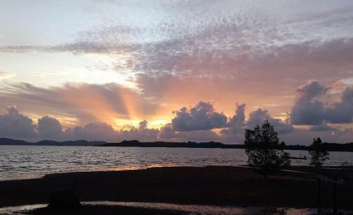 a sunset over a large body of water at Connexion in Ko Yao Noi