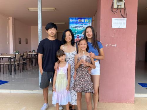a group of people standing next to a pink wall at Connexion in Ko Yao Noi